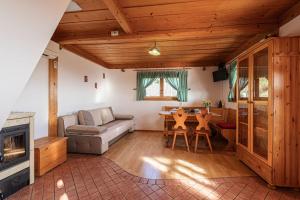 a living room with a couch and a table at Vineyard Chalet Hansel and Gretel - Happy Rentals in Otočec