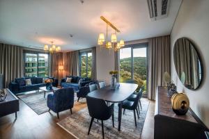 a living room with a table and chairs at Radisson Residences Vadistanbul in Istanbul