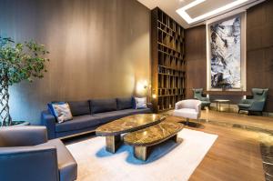 a living room with a couch and a table and chairs at Radisson Residences Vadistanbul in Istanbul