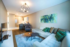 a living room with a couch and a table at Radisson Residences Vadistanbul in Istanbul
