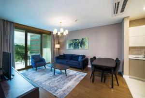 a living room with a couch and a table at Radisson Residences Vadistanbul in Istanbul