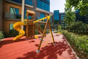 a playground with a slide in front of a building at Radisson Residences Vadistanbul in Istanbul