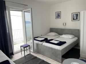 a bedroom with a bed and a large window at Apartments Gaspar in Podaca
