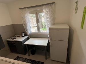 a small kitchen with a stove and a window at Apartments Gaspar in Podaca