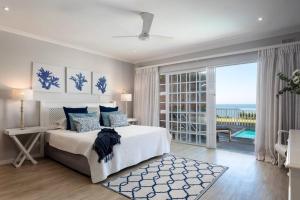 a bedroom with a bed and a view of the ocean at Cockleshell in Westbrook +37 photos