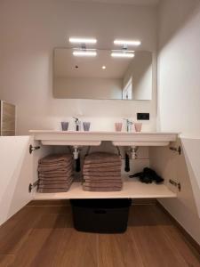 a bathroom with a sink and a mirror at ApartHotel Dénia in Lochristi +32 photos