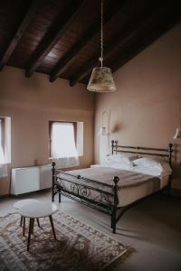 a bedroom with a bed and a table and a lamp at Agriturismo Pizzavacca in Villanova sullʼArda