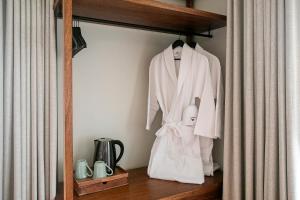 a shelf with a white robe and a doll on it at Casa Portuguesa - Charming House in Ponta Delgada