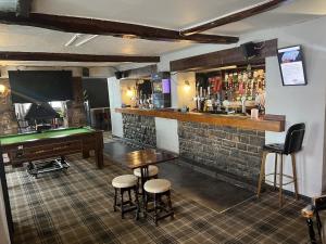 a bar with a pool table and a piano at The White Lion Hotel in Bridgend