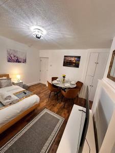 a bedroom with a bed and a table in it at Luxury London apartment in prime location in London
