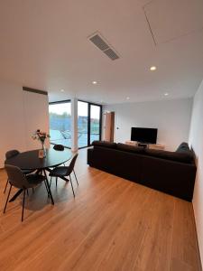 a living room with a couch and a table at ApartHotel Dénia in Lochristi