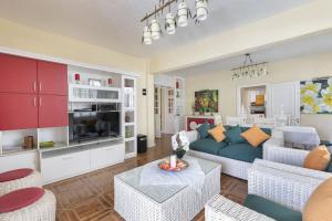 a living room with a blue couch and white furniture at Apartment Orchid in Mont Choisy