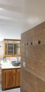 a bathroom with a sink and a counter top at Caraib'Bay Hotel in Deshaies