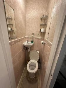 a small bathroom with a toilet and a sink at Sweet dream 3 in London
