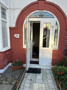 a red house with a white door and a window at Sweet dream 3 in London