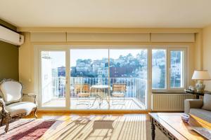 a living room with a large window and a balcony at Flat with Bosphorus View near Shore in Sariyer in Istanbul