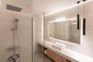 a bathroom with a sink and a mirror at Seven Hills, Boutique Apartments in Athens +16 photos