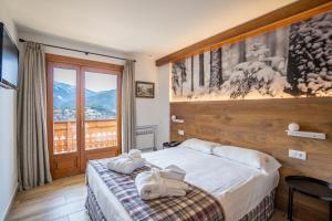Postel nebo postele na pokoji v ubytování Abba Ordino Babot Hotel