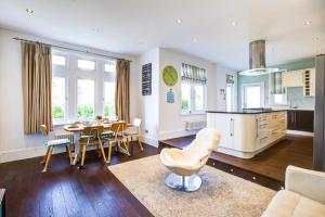 a kitchen and living room with a table and chairs at Pass the Keys Large house Leigh Sea views in Southend-on-Sea