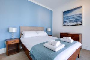 1 dormitorio con 1 cama con 2 toallas en Pass the Keys Large house Leigh Sea views en Southend-on-Sea