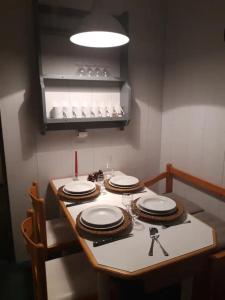 a table with plates on it in a kitchen at Appartement Tilia - Avoriaz in Avoriaz