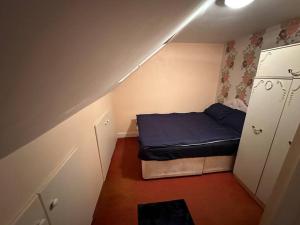 a small room with a bed in a attic at Sweet dream 4 in London