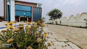 a group of flowers in front of a building at Buddha Resort hotel & restaurant,Aurangabad in Aurangābād