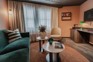 a living room with a couch and a tv at Funken Lodge in Longyearbyen