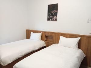 Postel nebo postele na pokoji v ubytování Lukang Inn