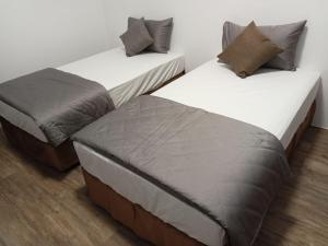 Postel nebo postele na pokoji v ubytování Lukang Inn