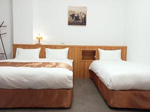 Postel nebo postele na pokoji v ubytování Lukang Inn