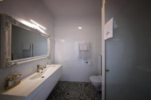 a bathroom with a sink and a mirror and a toilet at Lividus339 in Świnoujście