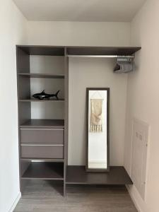 a walk in closet with a mirror and a shelf at Luxury 2BR Corner Apt Downtown MIA in Miami