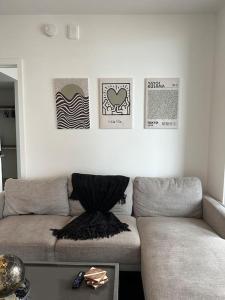 a living room with a couch and posters on the wall at Luxury 2BR Corner Apt Downtown MIA in Miami
