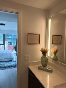 a bedroom with a vase on a counter with a mirror at Luxury 2BR Corner Apt Downtown MIA in Miami