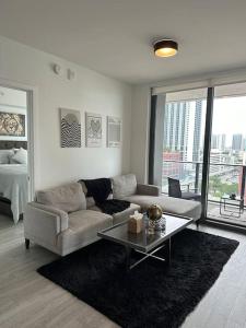 a living room with a couch and a table at Luxury 2BR Corner Apt Downtown MIA in Miami