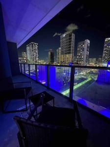 a balcony with a view of a city at night at Luxury 2BR Corner Apt Downtown MIA in Miami