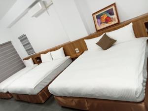 Postel nebo postele na pokoji v ubytování Lukang Inn