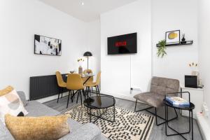 een woonkamer met een bank en een tafel bij Host Liverpool - Ideal for extended stays in Walton on the Hill