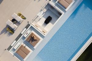 an overhead view of a swimming pool in a house at Asea Villa, Spectacular right-on-the-beach Retreat, By ThinkVilla in Skaleta