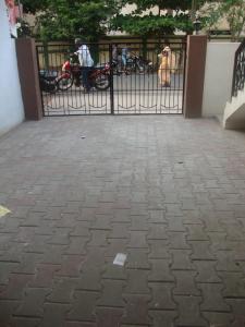 a black gate with a brick sidewalk in front at Srirangam Homestay in Srīrangam