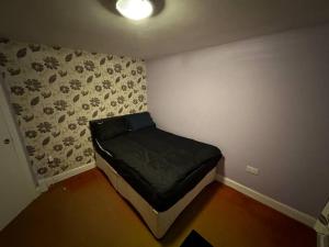 a small bedroom with a bed in the corner at Sweet dream 5 in London