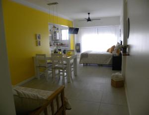 a room with a bed and a kitchen with a table at Crespo Apartament Premiun in Buenos Aires