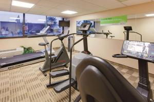 a gym with treadmill and ellipticals in a room at Ramada Inn by Wyndham Fairfield NJ in Fairfield