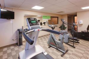 a gym with treadmills and elliptical machines at Ramada Inn by Wyndham Fairfield NJ in Fairfield
