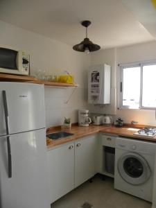 a kitchen with a white refrigerator and a dishwasher at Crespo Apartament Premiun in Buenos Aires