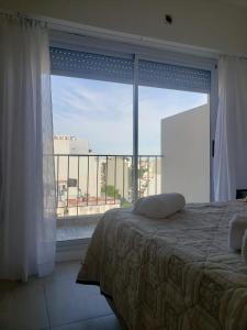 a bedroom with a bed and a large window at Crespo Apartament Premiun in Buenos Aires