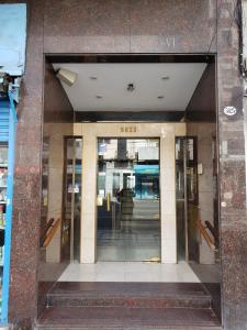 an entrance to a building with two glass doors at Crespo Apartament Premiun in Buenos Aires