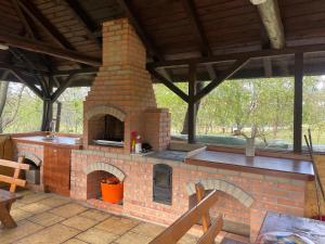 an outdoor brick oven with a wooden roof at Pensiunea MIS in Bran