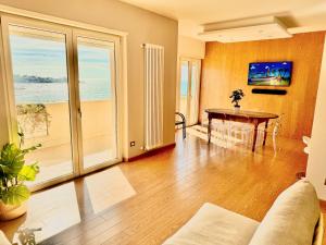 a living room with a couch and a table at Seaside Suite in Civitavecchia
